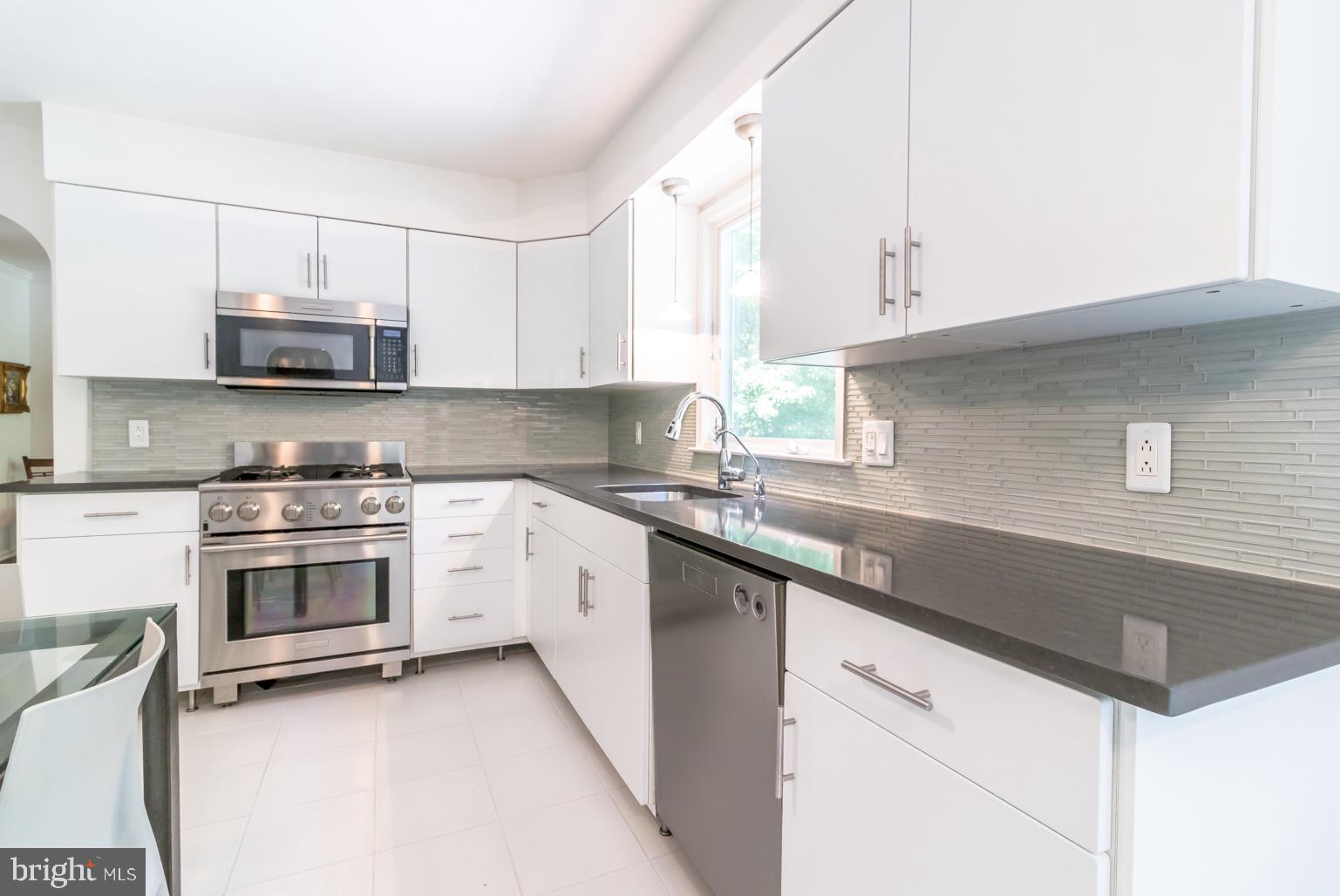 59 Tindall Road Trenton, NJ 08691 - Photo 22 of 76 a kitchen with cabinets appliances a sink and a window