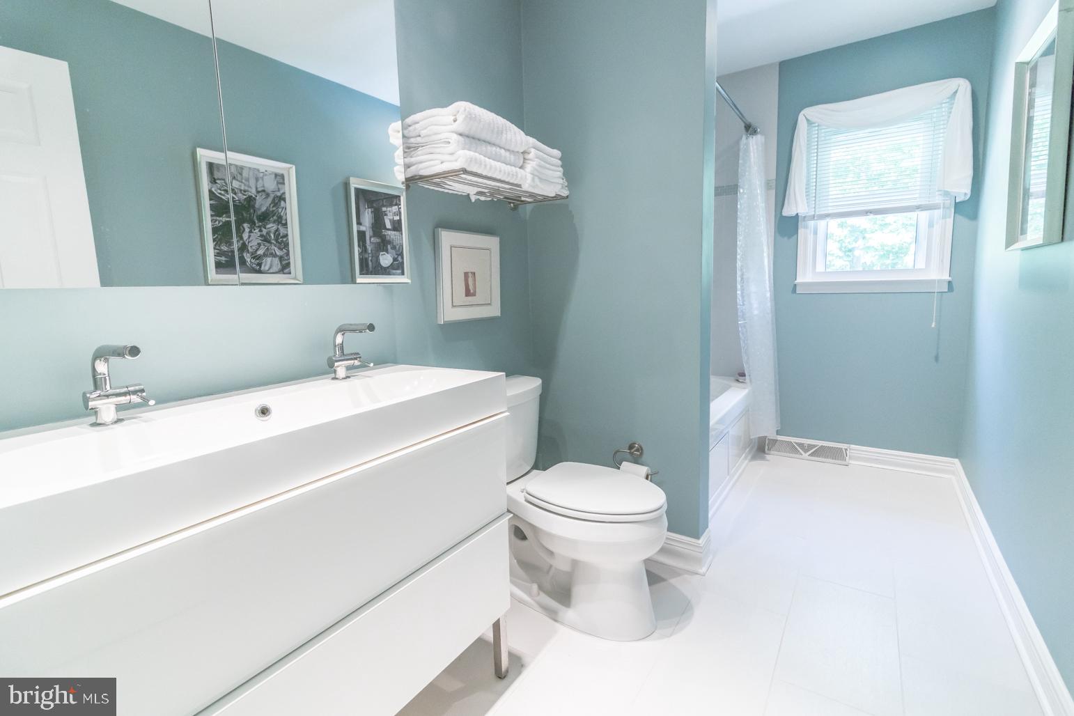 59 Tindall Road Trenton, NJ 08691 - Photo 44 of 76 a white toilet sitting next to a bathroom sink