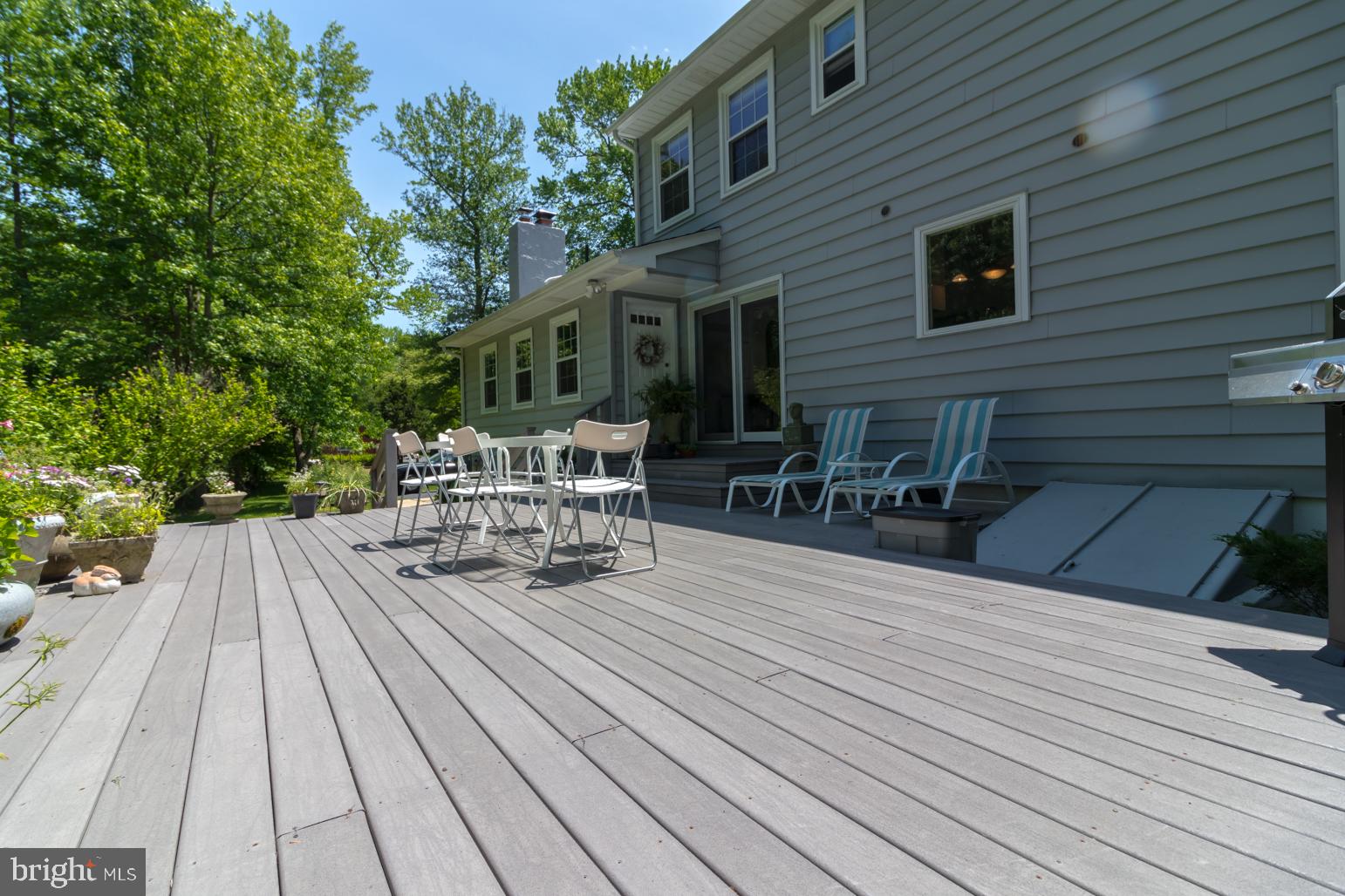 59 Tindall Road Trenton, NJ 08691 - Photo 66 of 76 a view of house with deck outdoor seating and trees in the background