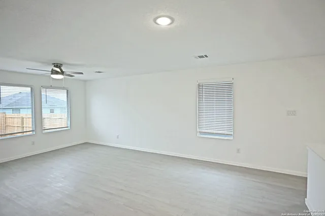 an empty room with a empty space and windows