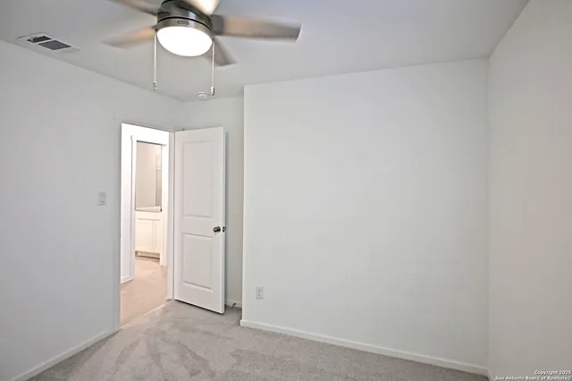 a view of a chandelier fan and closet area