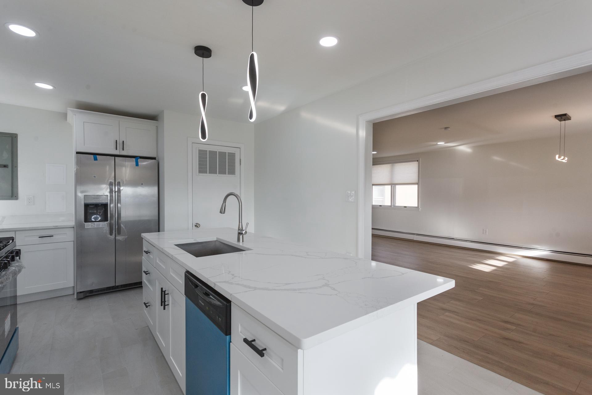 1007 Ripley Street Philadelphia, PA 19111 - Photo 11 of 27 a kitchen with a sink a counter space and stainless steel appliances