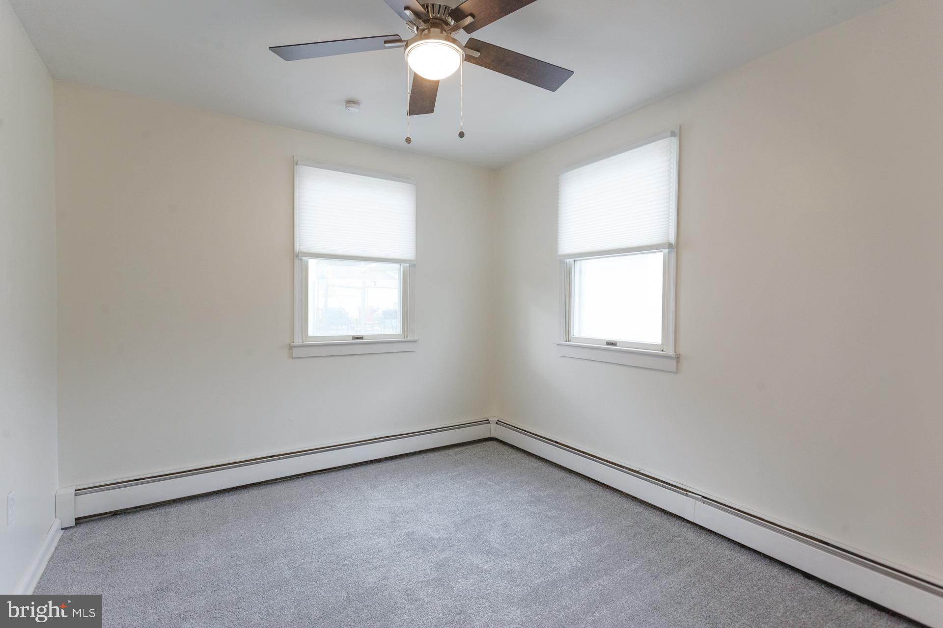 1007 Ripley Street Philadelphia, PA 19111 - Photo 17 of 27 an empty room with a window and a fan