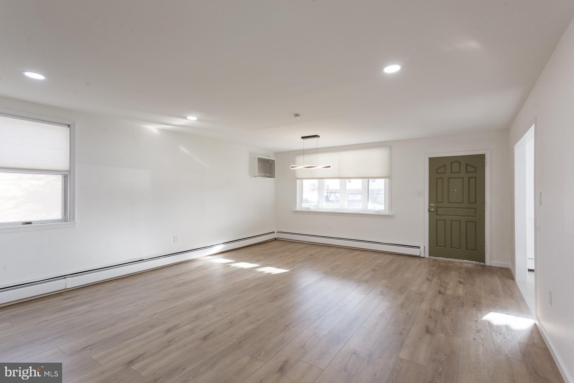 1007 Ripley Street Philadelphia, PA 19111 - Photo 3 of 27 an empty room with wooden floor and windows