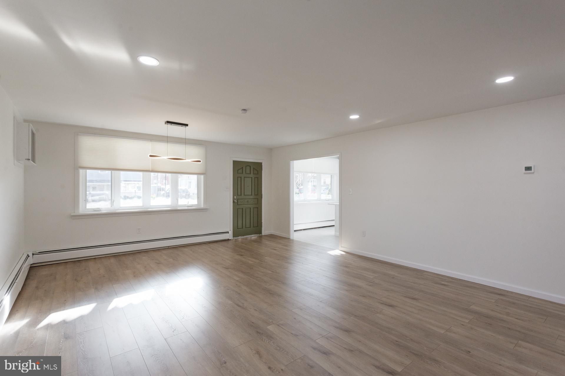 1007 Ripley Street Philadelphia, PA 19111 - Photo 4 of 27 an empty room with wooden floor and windows