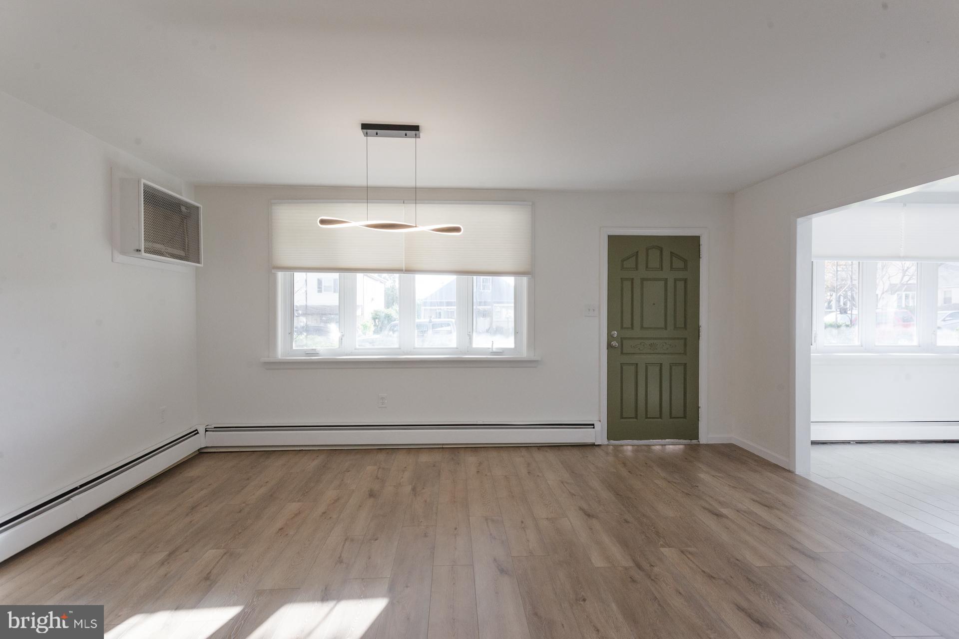 1007 Ripley Street Philadelphia, PA 19111 - Photo 5 of 27 an empty room with wooden floor and windows