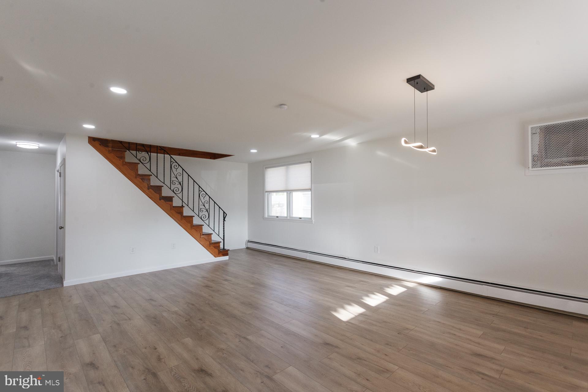 1007 Ripley Street Philadelphia, PA 19111 - Photo 8 of 27 a view of an empty room with wooden floor and staircase