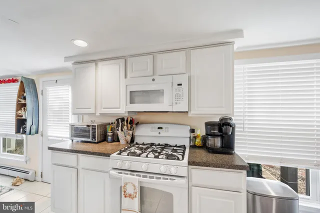 a kitchen with cabinets a stove and a window