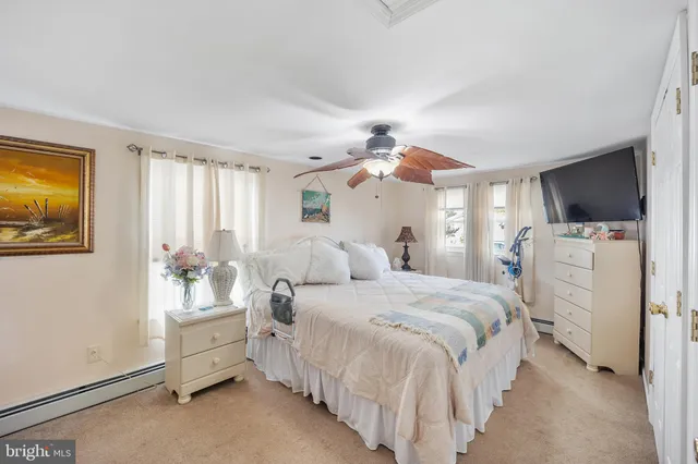a bedroom with bed and a chandelier