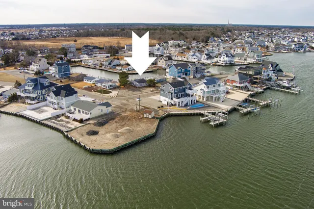 a view of water heater and room with wooden floor