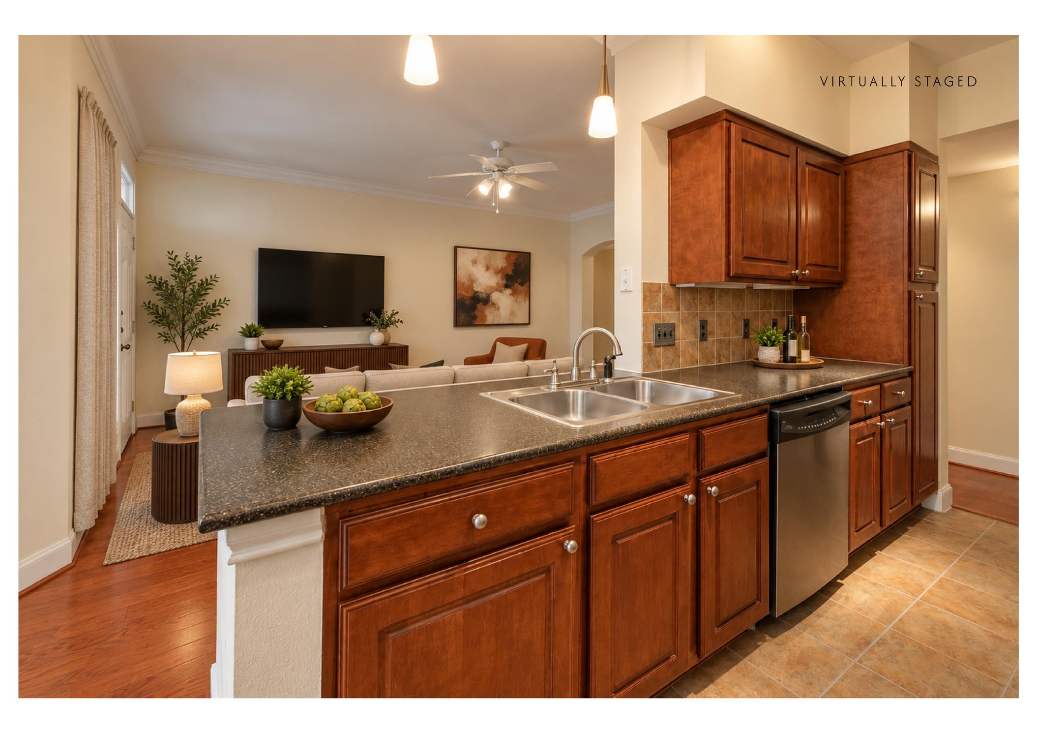 7701 Rialto Boulevard, Unit 1326 Austin, TX 78735 - Photo 7 of 20 The staged version shows how it could look: an open kitchen layout features rich wood cabinetry and views into the adjacent living space.