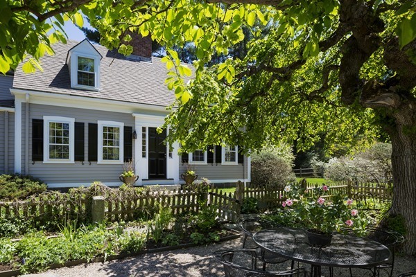 55 Willow Street Dover, MA 02030 - Photo 2 of 22 a front view of a house with a garden