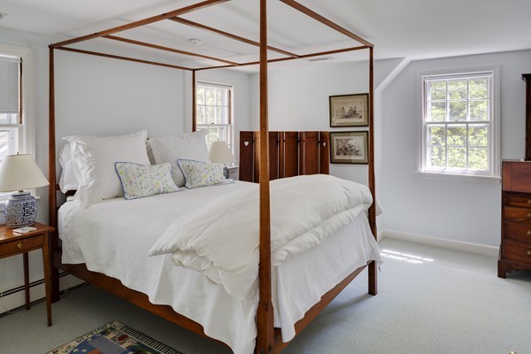 55 Willow Street Dover, MA 02030 - Photo 21 of 22 a large bed sitting in a bedroom next to a window