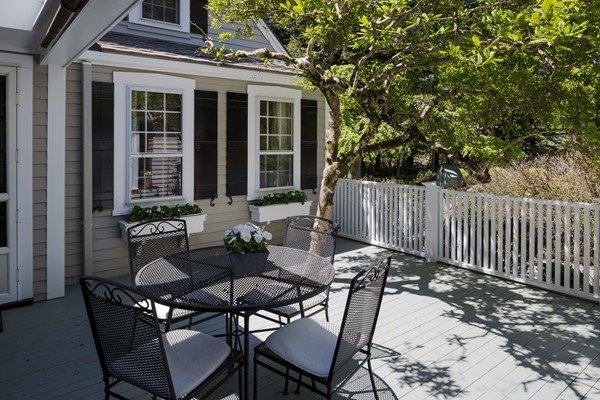 55 Willow Street Dover, MA 02030 - Photo 4 of 22 a view of a patio with table and chairs and wooden fence