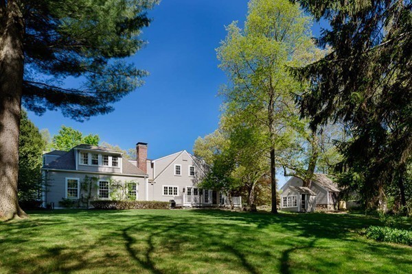 55 Willow Street Dover, MA 02030 - Photo 10 of 22 a view of a white house with a big yard and large trees
