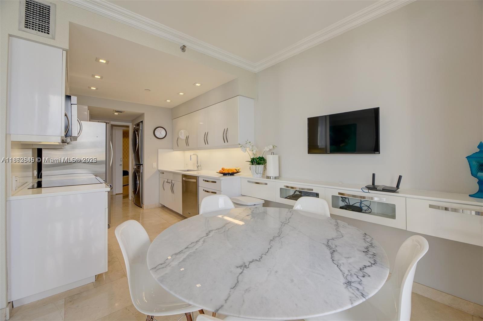 3000 East Island Boulevard, Unit 801 Aventura, FL 33160 - Photo 11 of 36 a living room with furniture and a flat screen tv