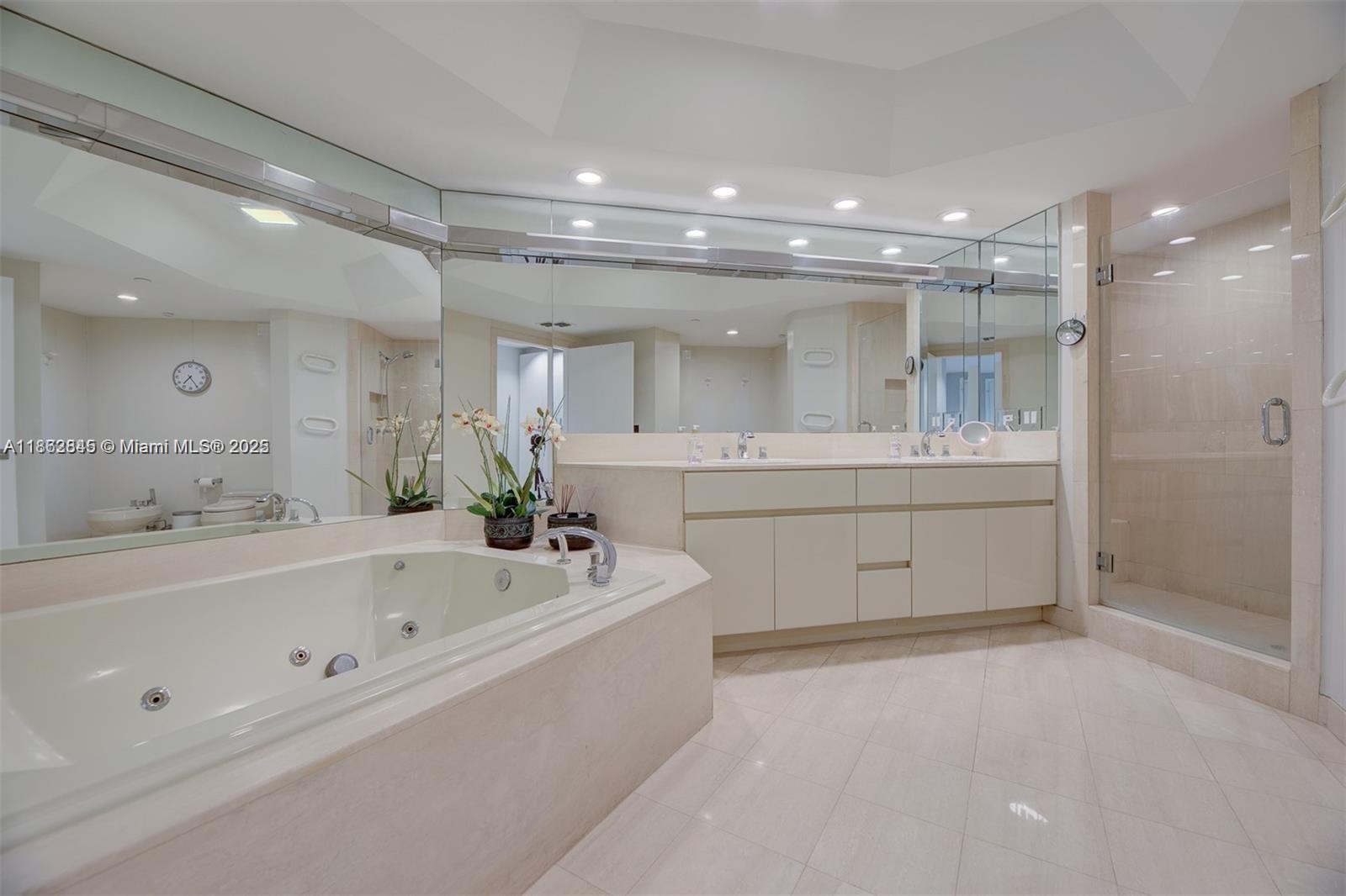 3000 East Island Boulevard, Unit 801 Aventura, FL 33160 - Photo 17 of 36 a bathroom with a bathtub a sink and a mirror