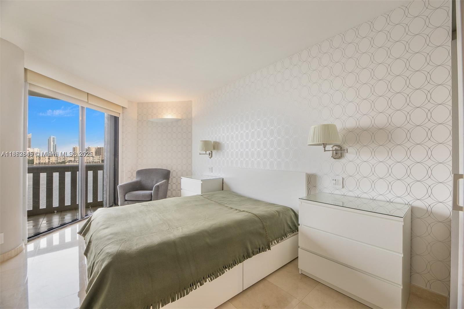 3000 East Island Boulevard, Unit 801 Aventura, FL 33160 - Photo 20 of 36 a bedroom with a bed and a cabinets