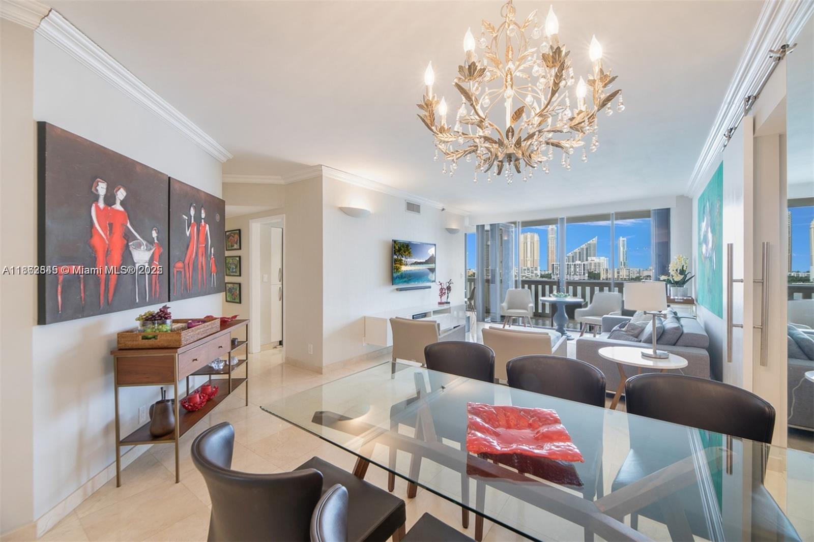 3000 East Island Boulevard, Unit 801 Aventura, FL 33160 - Photo 2 of 36 a living room with furniture a couch and a chandelier