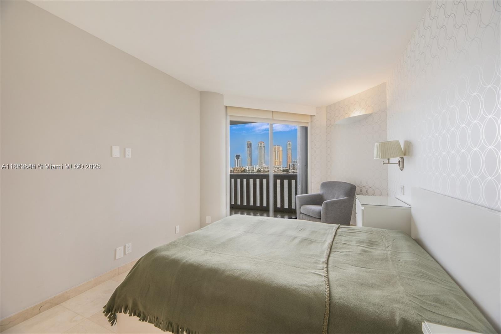 3000 East Island Boulevard, Unit 801 Aventura, FL 33160 - Photo 21 of 36 a bedroom with a bed and a window