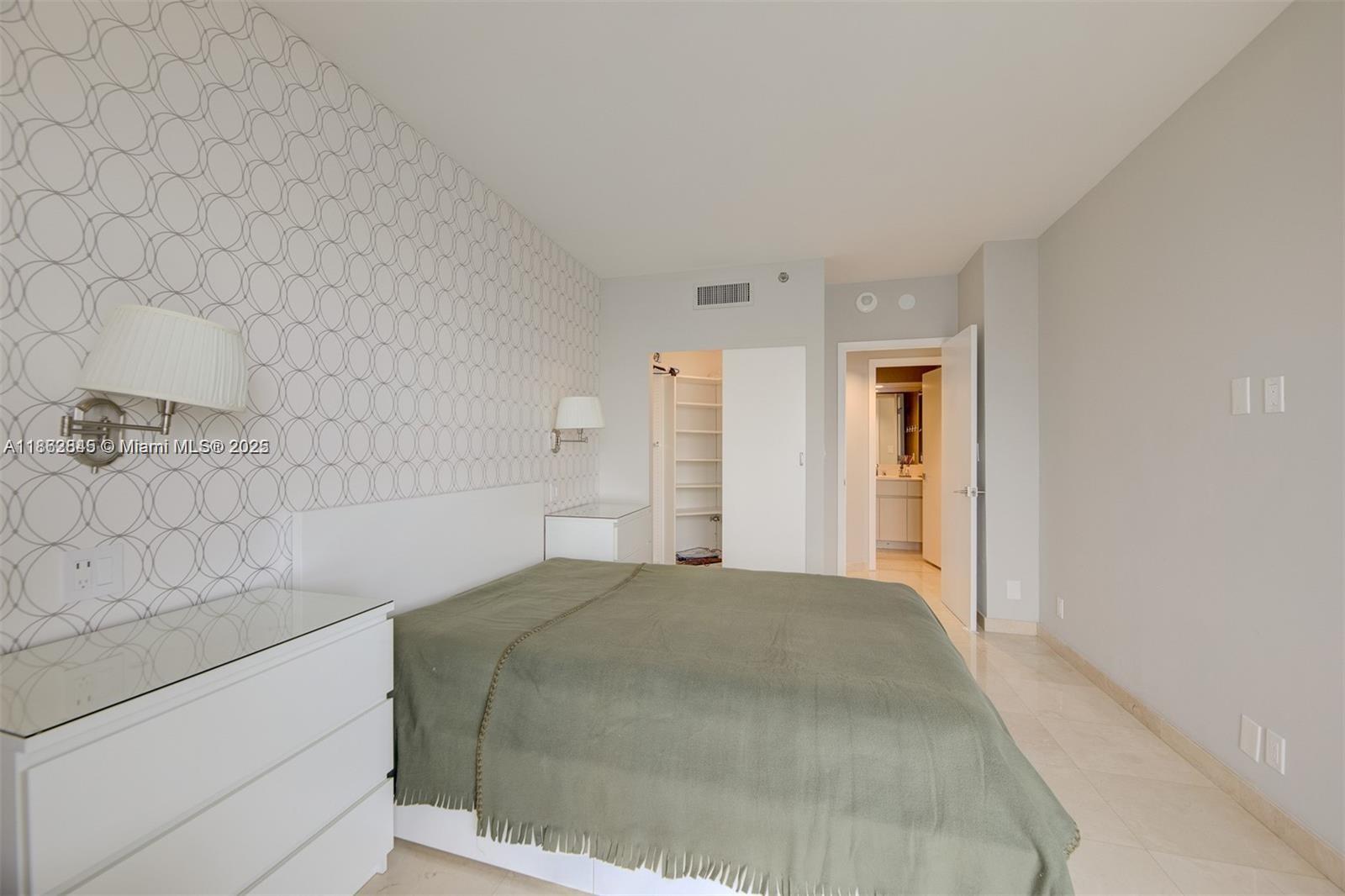 3000 East Island Boulevard, Unit 801 Aventura, FL 33160 - Photo 22 of 36 a bedroom with a bed and a cabinets