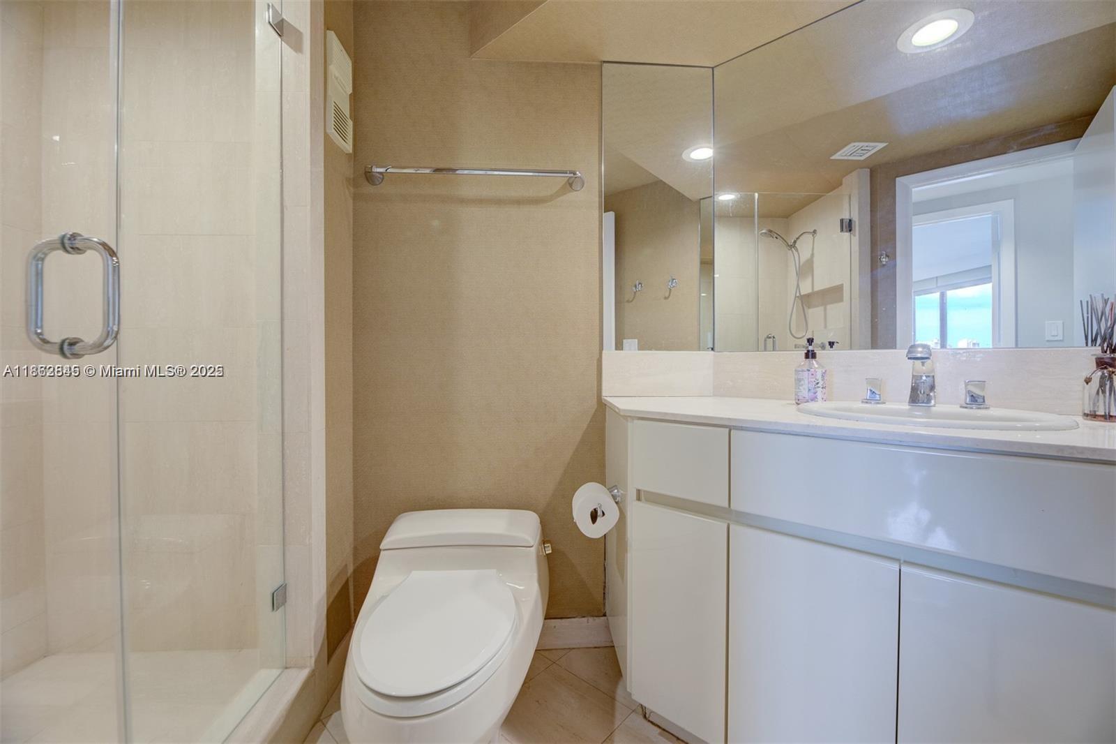 3000 East Island Boulevard, Unit 801 Aventura, FL 33160 - Photo 23 of 36 a bathroom with a sink a toilet and shower