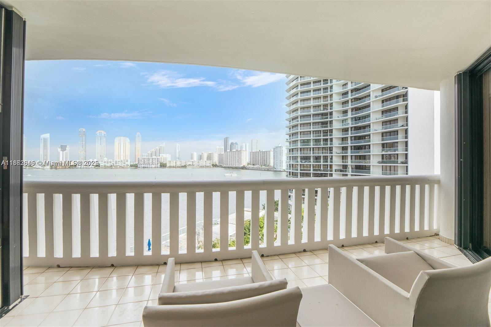 3000 East Island Boulevard, Unit 801 Aventura, FL 33160 - Photo 26 of 36 a balcony with a couch