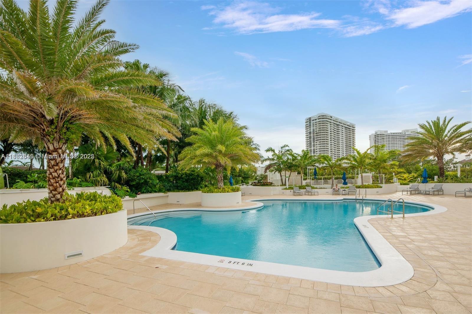 3000 East Island Boulevard, Unit 801 Aventura, FL 33160 - Photo 30 of 36 a view of a swimming pool and a yard