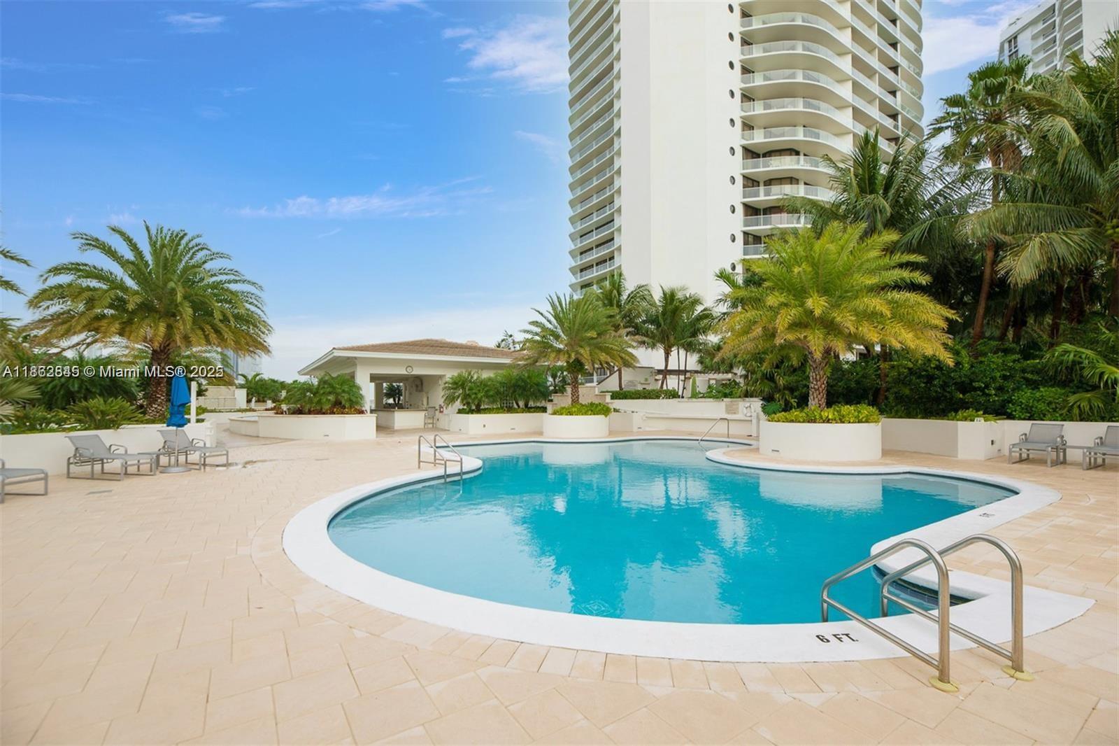3000 East Island Boulevard, Unit 801 Aventura, FL 33160 - Photo 31 of 36 a view of a swimming pool with a lawn chairs