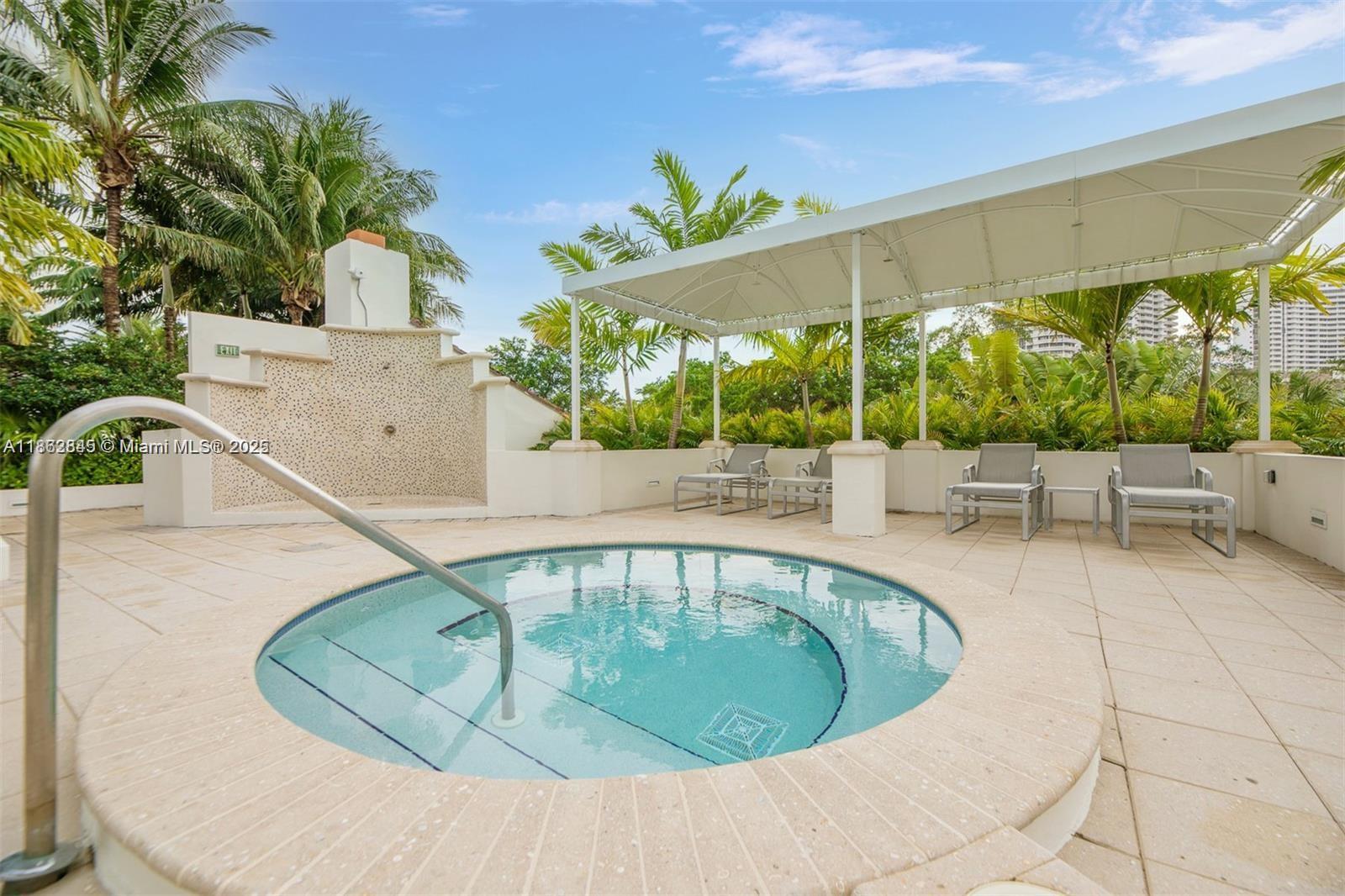 3000 East Island Boulevard, Unit 801 Aventura, FL 33160 - Photo 32 of 36 a swimming pool with outdoor seating and yard