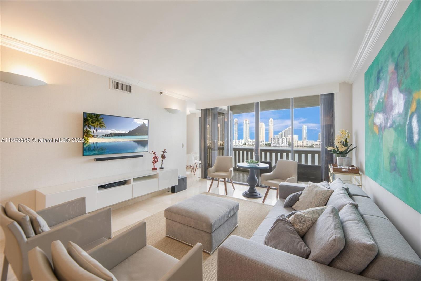 3000 East Island Boulevard, Unit 801 Aventura, FL 33160 - Photo 4 of 36 a living room with furniture and a flat screen tv