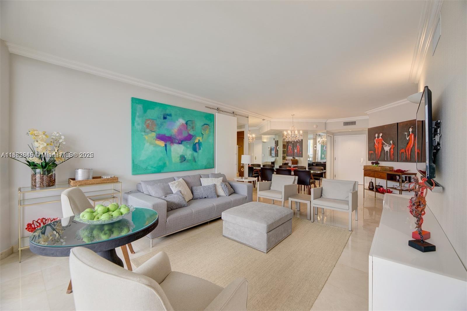 3000 East Island Boulevard, Unit 801 Aventura, FL 33160 - Photo 6 of 36 a living room with furniture and a flat screen tv