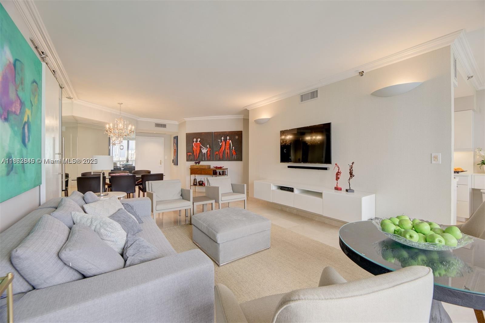 3000 East Island Boulevard, Unit 801 Aventura, FL 33160 - Photo 7 of 36 a living room with furniture and a flat screen tv