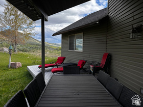1940 East Shore Road St. Charles, ID 83272 - Photo 59 of 64 Wooden terrace featuring a lawn, an outdoor hangout area, and a mountain view