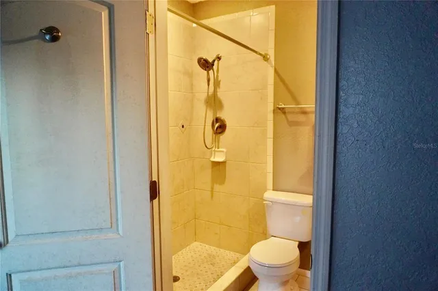 an empty room with wooden floor and closet