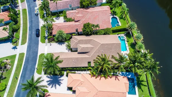 an aerial view of residential houses with outdoor space and street view