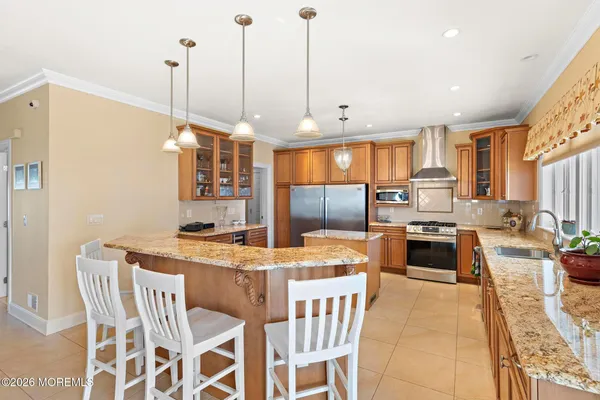 a spacious bedroom with a bed and a chandelier