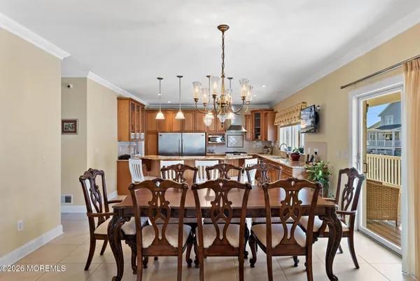 a view of a balcony with chairs and iron fence