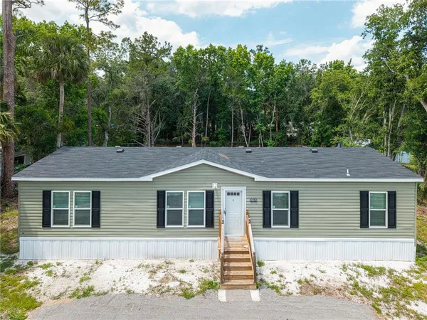 a house with trees in the background