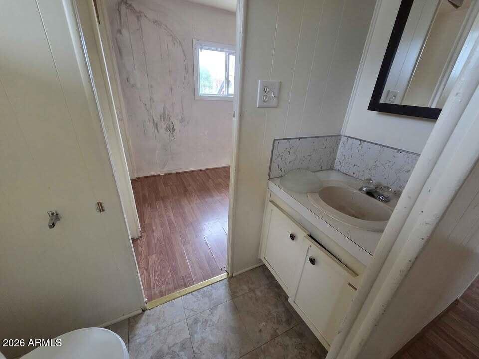730 Tesota Quartzsite, AZ 85346 - Photo 12 of 15 a bathroom with a granite countertop sink and a mirror