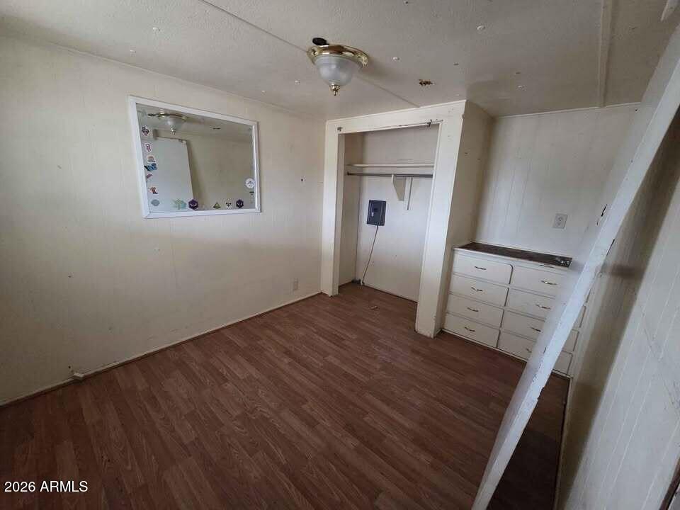 730 Tesota Quartzsite, AZ 85346 - Photo 15 of 15 a view of an empty room with wooden floor and a window