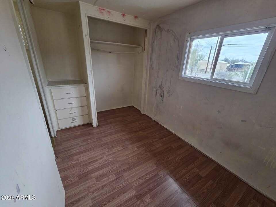730 Tesota Quartzsite, AZ 85346 - Photo 8 of 15 wooden floor in an empty room with a window