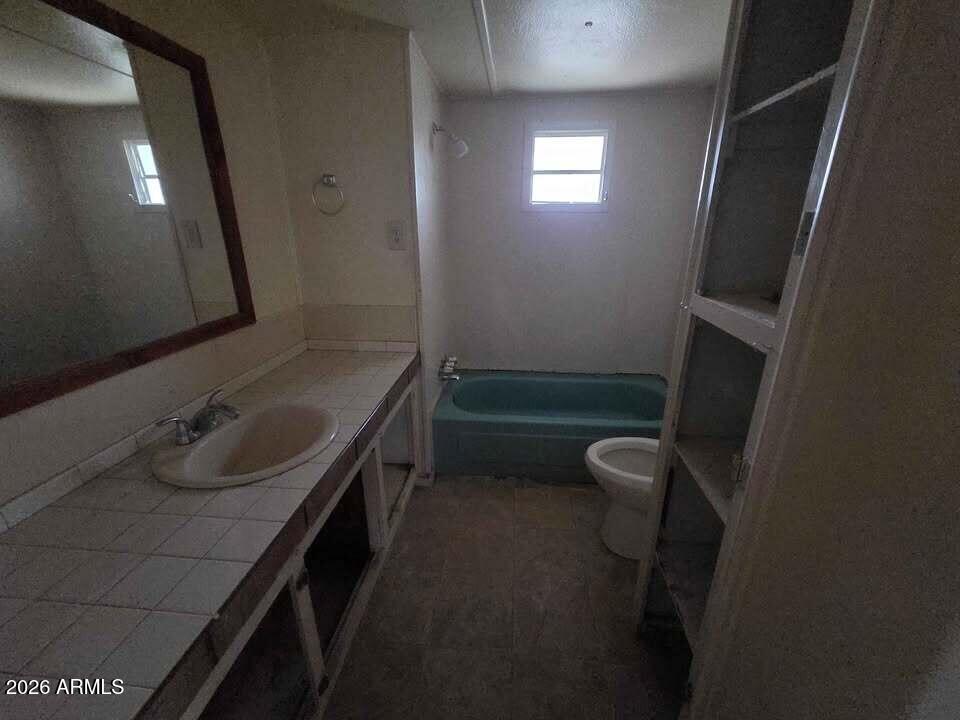 730 Tesota Quartzsite, AZ 85346 - Photo 10 of 15 a bathroom with a sink toilet double vanity