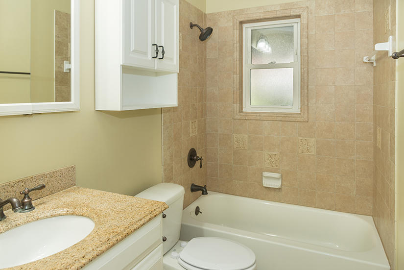 611 Lang Road Fort Walton Beach, FL 32547 - Photo 18 of 26 a bathroom with a granite countertop sink toilet and shower