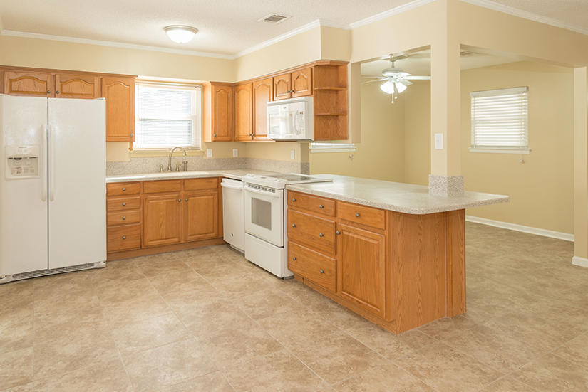 611 Lang Road Fort Walton Beach, FL 32547 - Photo 3 of 26 a large kitchen with stainless steel appliances granite countertop a sink and cabinets