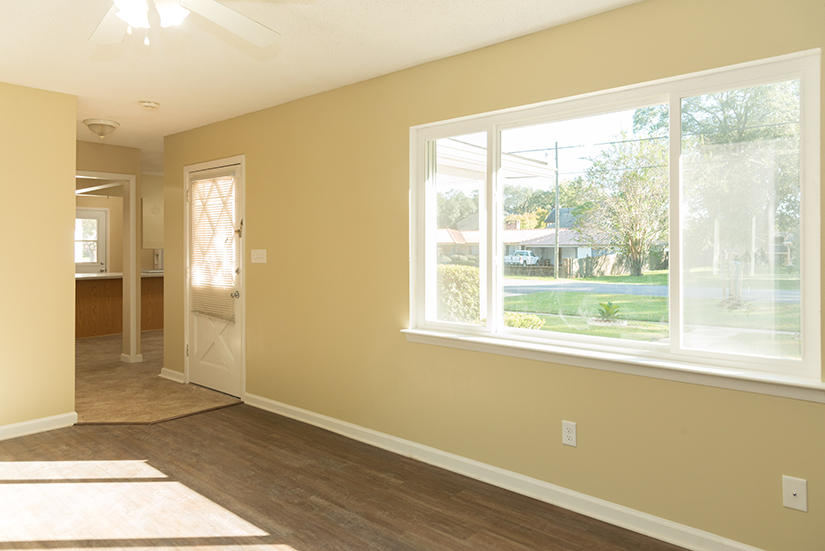 611 Lang Road Fort Walton Beach, FL 32547 - Photo 6 of 26 a view of an empty room with wooden floor and a window
