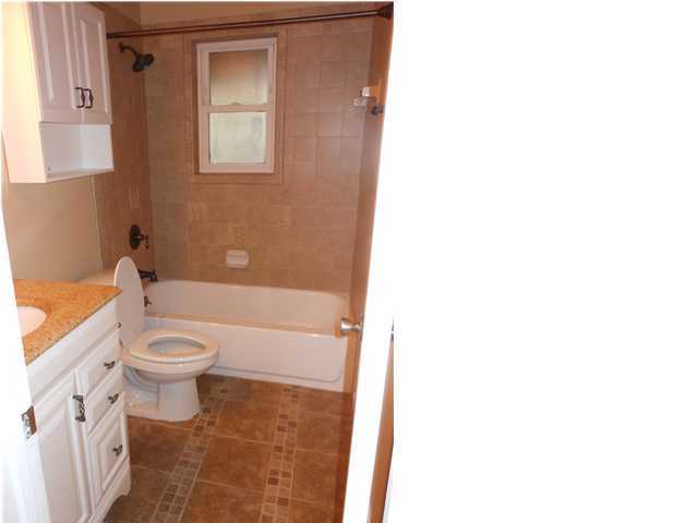 611 Lang Road Fort Walton Beach, FL 32547 - Photo 8 of 26 a bathroom with a toilet a sink and a bathtub