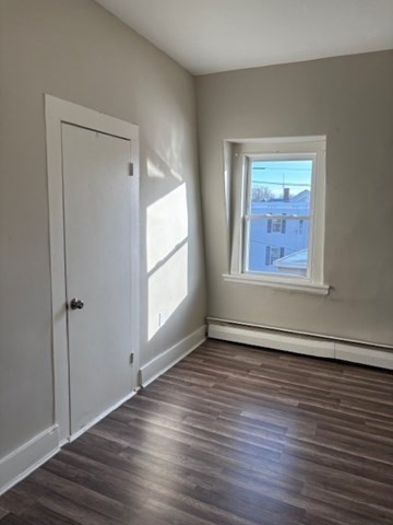 58 Bridge Street, Unit 2M Salem, MA 01970 - Photo 3 of 11 an empty room with wooden floor and windows