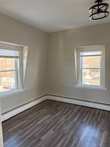 58 Bridge Street, Unit 2M Salem, MA 01970 - Photo 5 of 11 a view of an empty room with wooden floor and a window