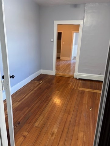 58 Bridge Street, Unit 2M Salem, MA 01970 - Photo 9 of 11 a view of an empty room with wooden floor and a window
